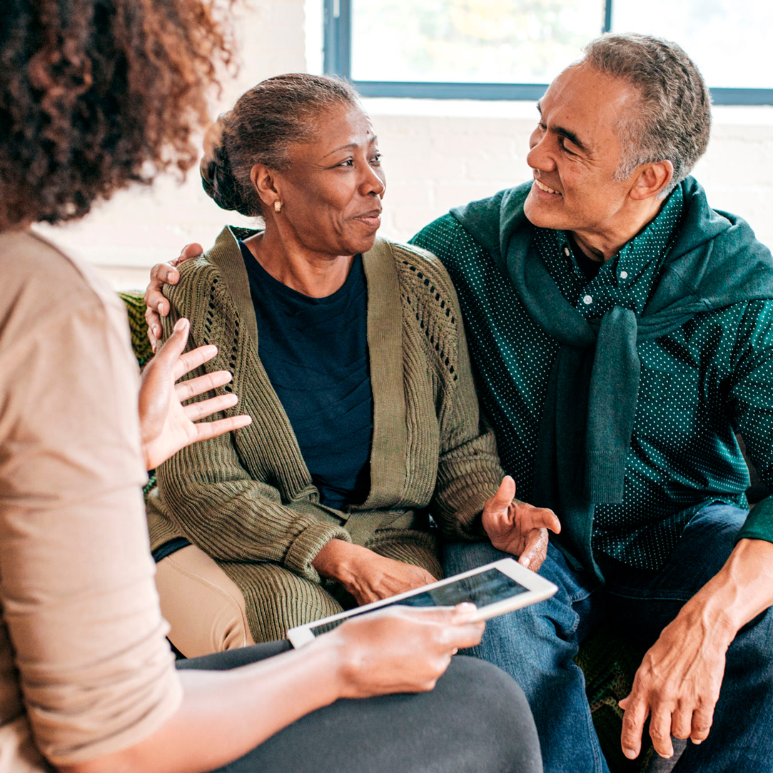 Woman talking to couple, couple is looking at each other